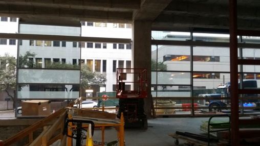 View of ASH through the partially constructed first floor curtain wall system.