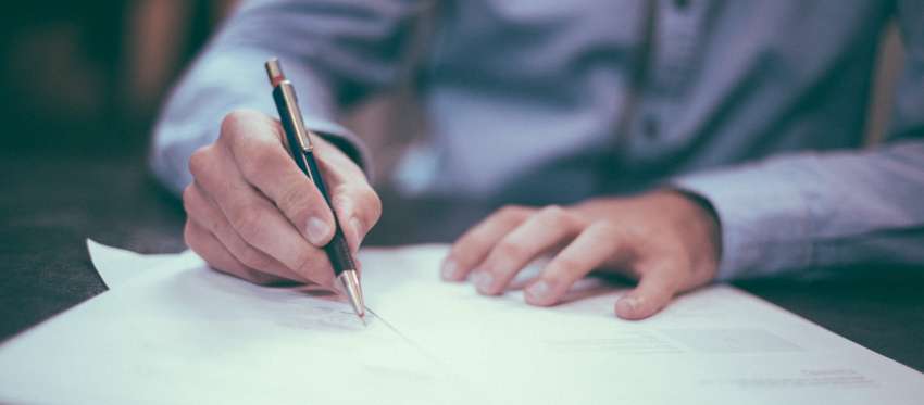 A man writes on documents
