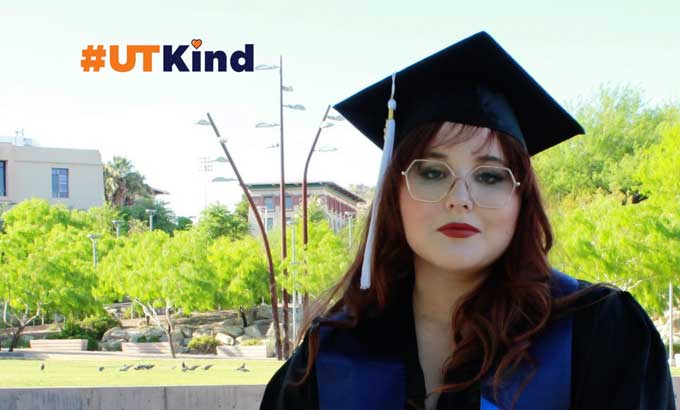 Recent graduate Sarah Mickelson, sitting outside in her graduation gown and cap