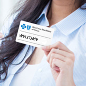 Woman holding insurance ID Card.