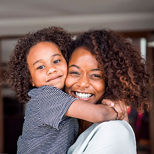 Mother and daughter smiling