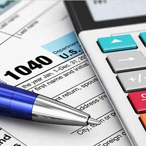 Federal Tax Form with pen and calculator