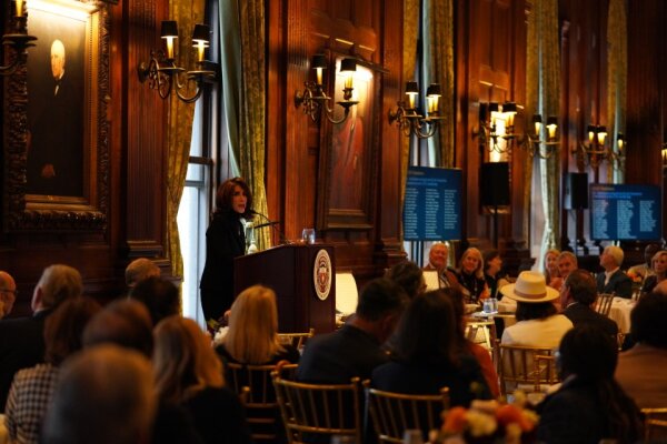CCEC Chair giving a talk at the podium to the CCEC crowd