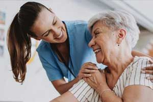 a nurse and patient holding hands