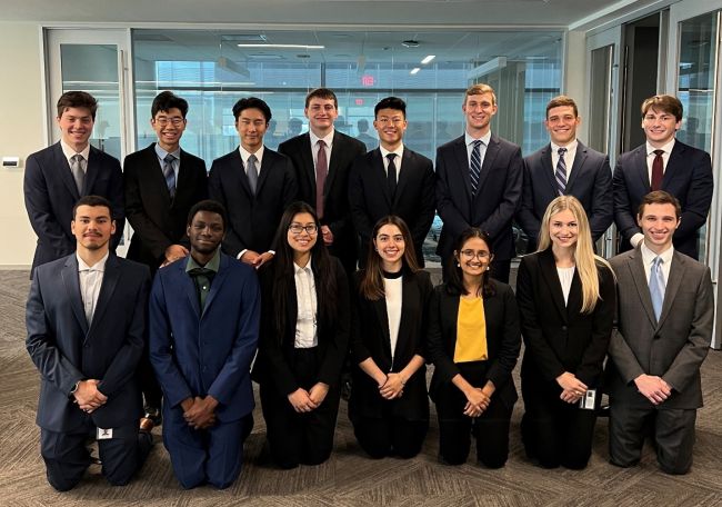 Group photo of Growing Investment Leaders interns in two rows of business attire and smiling