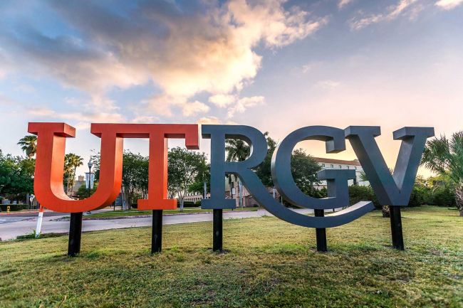 Outside signage with the letters UTRGV. UT is in orange, and RGV in a dark gray