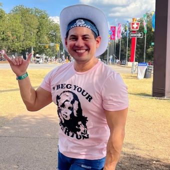 Johnny Reyes taking in some outdoor time, smiling in a cowboy hat