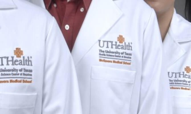 A group of people in white lab coats, cropped to emphasize the UTHealth Houston logo.