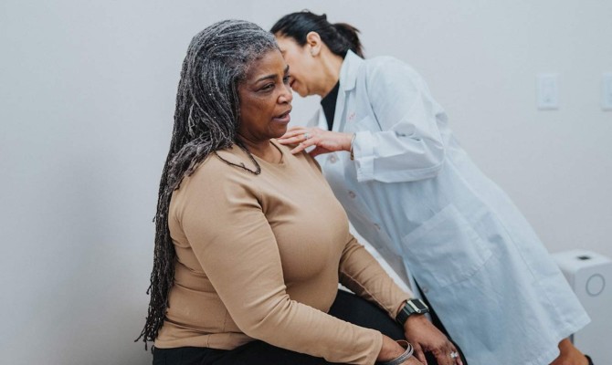 Doctor examining senior woman