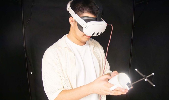 Computer science doctoral student Daniel Honrales demonstrates PropType, a patent-pending technology that overlays an augmented keyboard surface onto handheld objects.