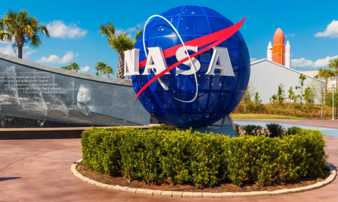 A large globe sculpture with the NASA logo