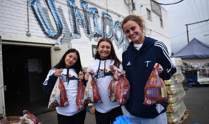 UTEP students help hand out food to community members at the Kelly Center for Hunger Relief.