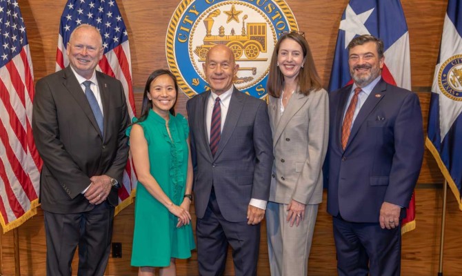 Leadership standing in front of the seal: Dean Eric Boerwinkle, PhD; Theresa Tran, MD; Mayor John Whitmire; President Melina R. Kibbe, MD; and Scott Forbes.