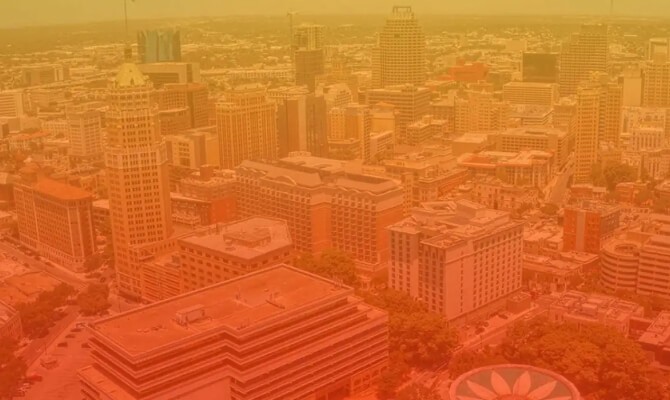 An aerial photo of San Antonio with an orange overlay on it.