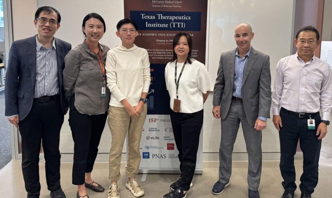 Six people stand in a hallway in front of a Texas Therapeutics Institute banner.