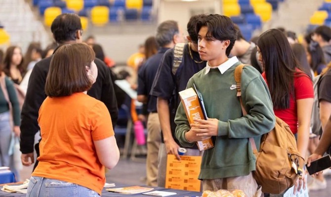 High School students at a table of a UT El Paso recruiter