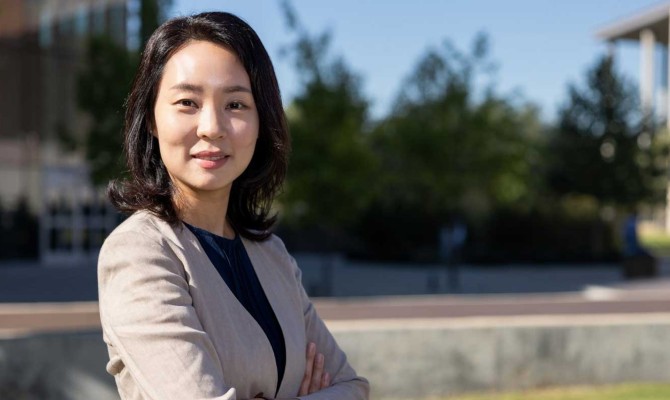 Dr. Kate Hyun outdoor with her arms crossed