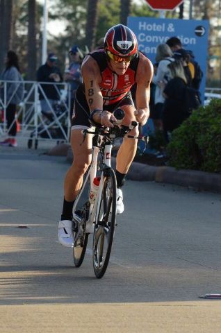 Eric Solberg, UT System Associate Vice Chancellor, Health Affairs, rides his bike competing in an Ironman competition.
