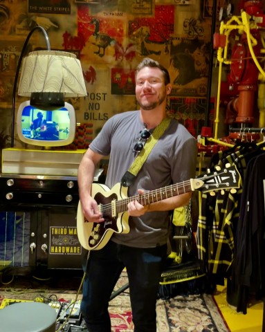 Trevor Hand, UT System's legislative coordinator in the Office of Government Relations, plays his guitar