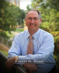 Rodney Mabry outside on the commons of UT Tyler with the text "Rodney H. Mabry" appearing at the bottom of the screen