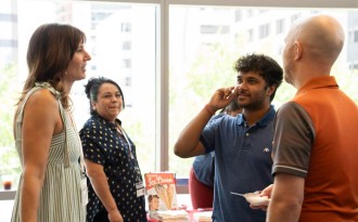 Intern Harikrishnan Mamparambath in conversation with staff (Photo: Maddie Marroquin)
