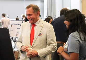 Intern Navya Verma in conversation with Chancellor John M. Zerwas (Photo: Sarah LaRose)