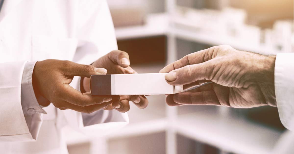 Pharmacists hands exchanging medication
